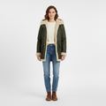 Front view of a green hooded winter coat with cream shearling lining