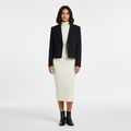 Front view of a cropped navy blazer with notched lapels and one button