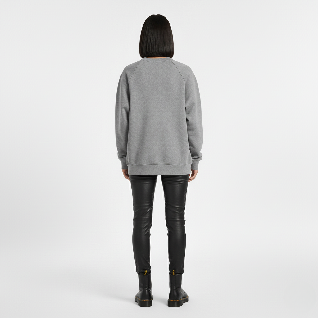 Grey oversized crew neck sweatshirt seen from the back with black trousers