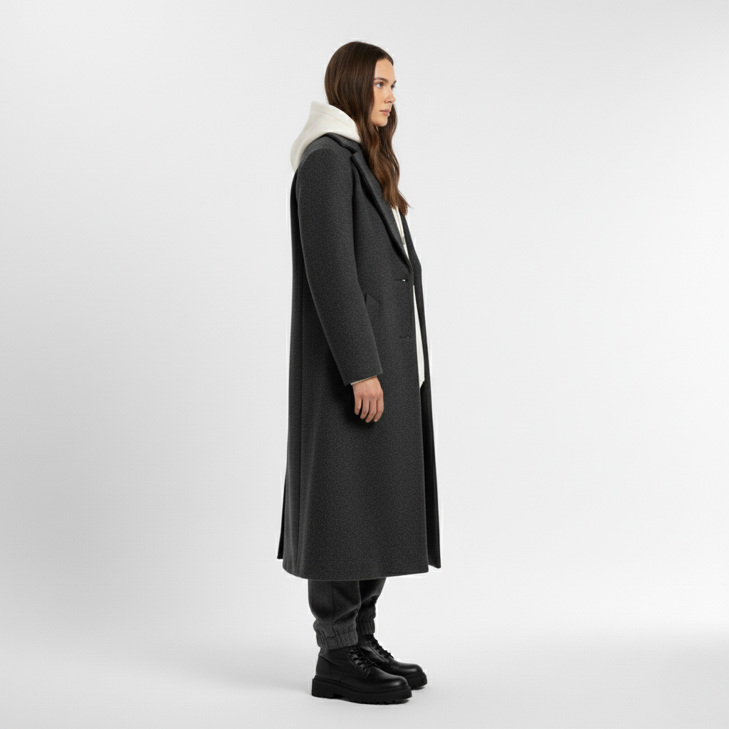 Side view of a woman in a long grey wool coat with black lace up boots